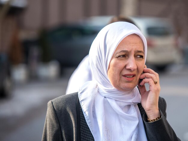 Islamic woman talking on cellphone