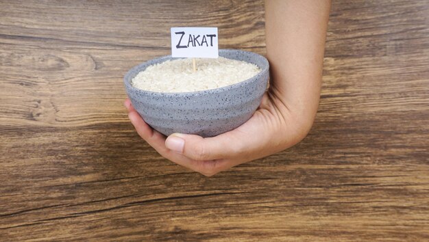 Islamic zakat concept selective focus image rice on hand palm