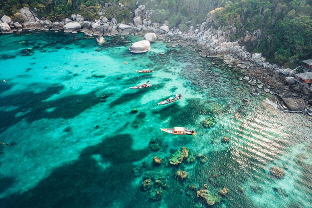 Island and boat in clear sea at Koh Tao