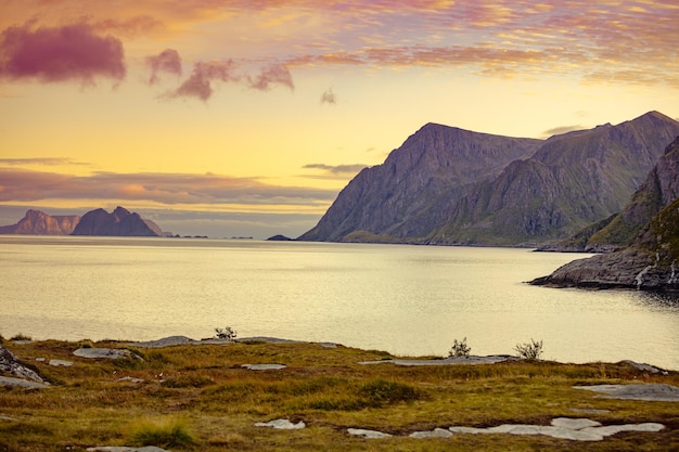 Island on the horizon Rocks in the sea Beautiful rocky shore of the fjord in the evening