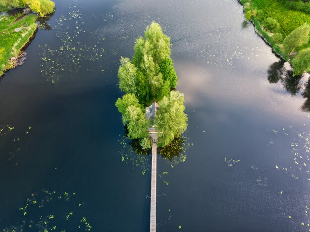 An island in the middle of a river with a small house