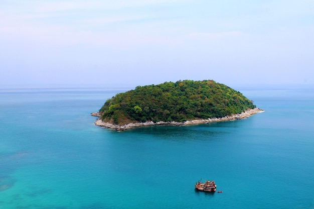 Photo island and two small fishing boats in the azure waters of the indian ocean phuket island thailand