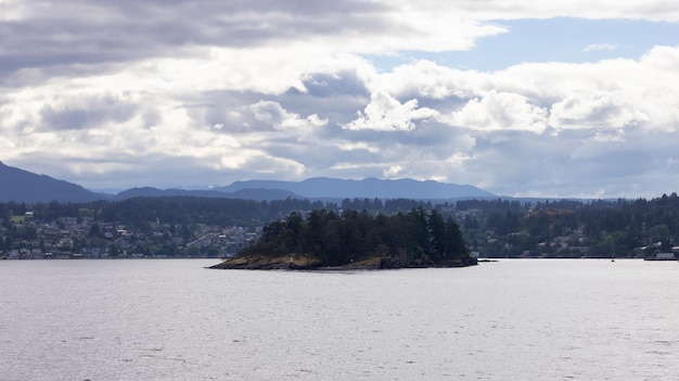 Islands with trees and lighthouse surrounded by homes on a cloudy day