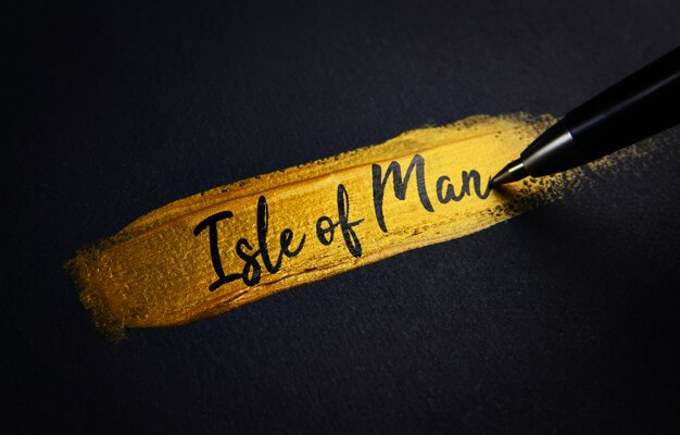 Isle of Man Handwriting Text on Golden Paint Brush Stroke