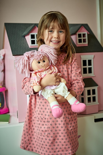 Photo isnt she as cute as me portrait of an adorable little girl playing with her toys at home