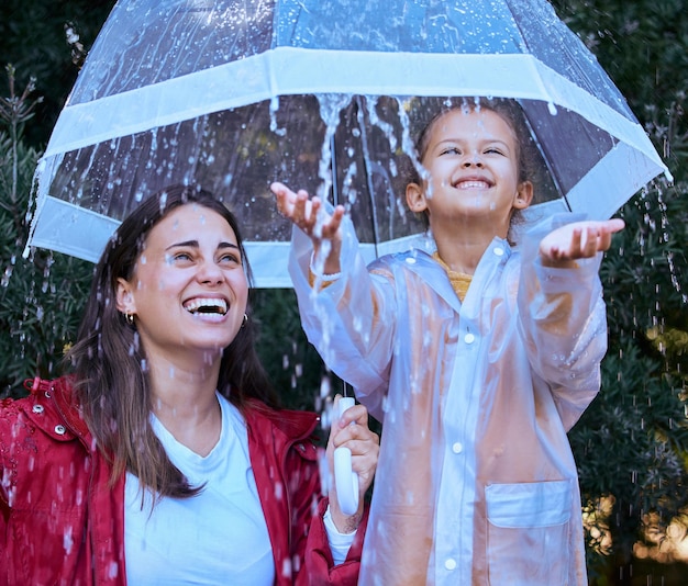 Isnt this the best feeling Shot of a mother playing in the rain with her daughter