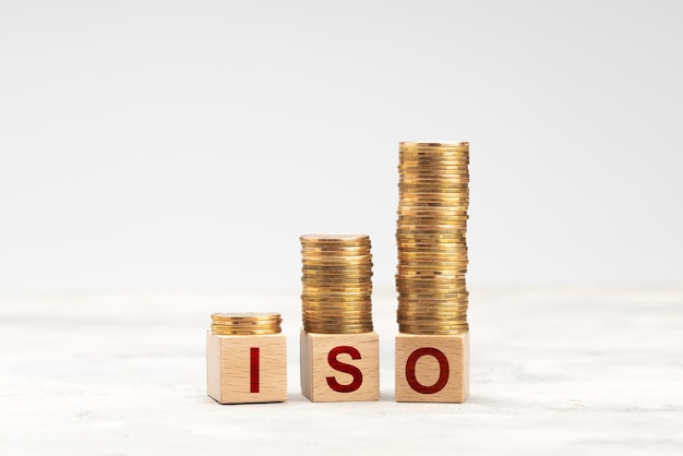 ISO and stack of coins on a gray background