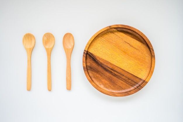 Isolate circle wood plate and three wood spoon 