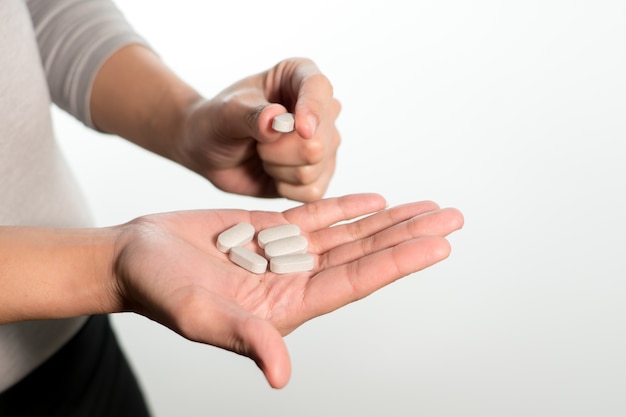 Isolate of the women hand holding the medicines, medicine recovery concept