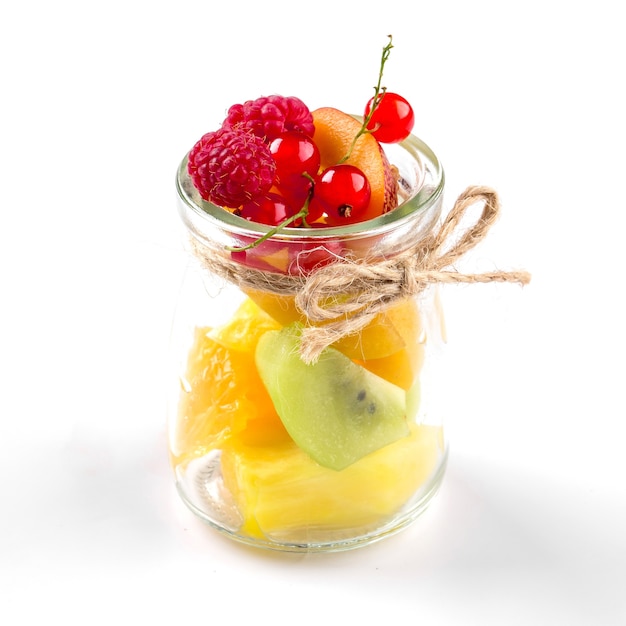 Isolated assorted fruit mix in a glass jar