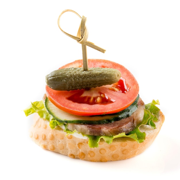 Isolated bruschetta with pickle meat and tomato on the white surface