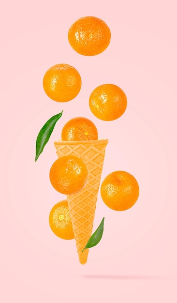 Isolated clementine on the air in ice cream waffle cone