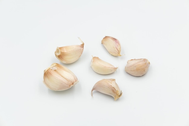 Isolated fresh raw garlic cloves on white background