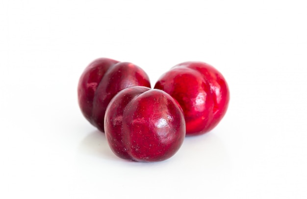 Isolated of Fresh red cherry plum on white 