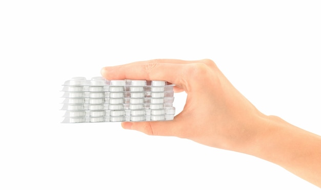 Isolated hand with packs of white pills