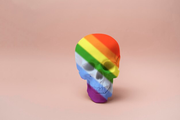 The isolated human skull made of rainbow colors symbol of halloween