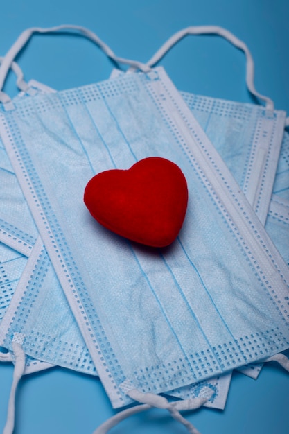 Isolated image of face masks with a red heart. Valentine concept.