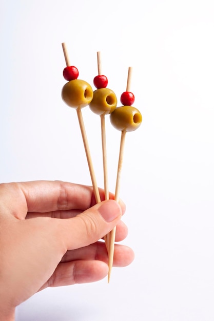 Isolated olives on skewers with white background