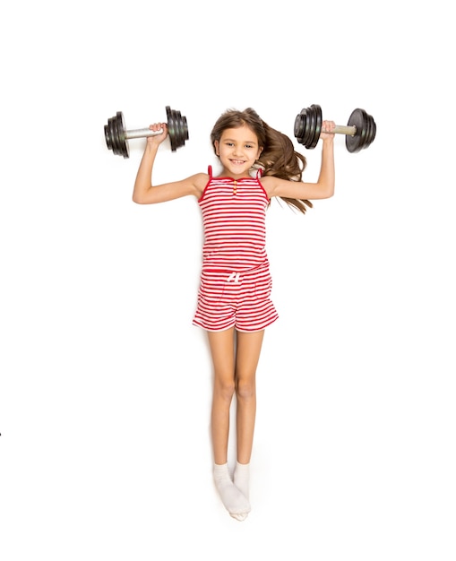 Isolated photo from high point view of cute girl lying on floor and doing exercise with dumbbells