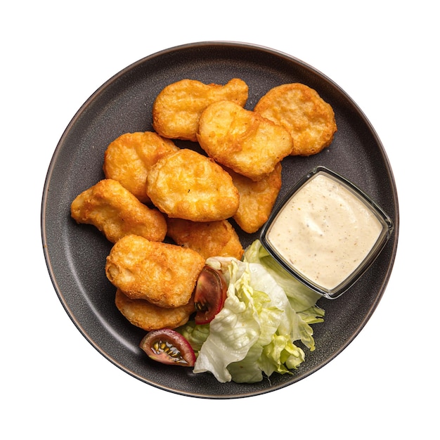 Isolated portion of chicken nuggets with sauce