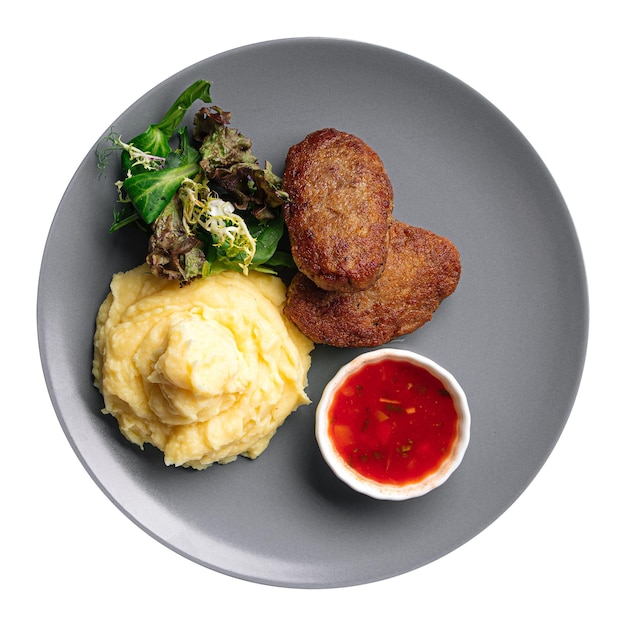 Isolated portion of veal cutlet with mashed potato