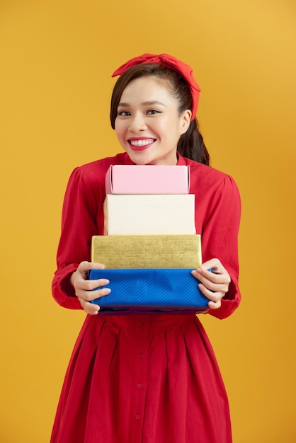 Isolated portrait one woman with gifts on yellow background