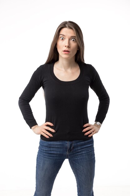 Isolated portrait of a surprised and shocked young woman looking