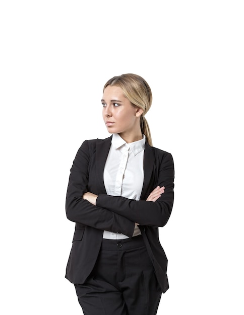 Isolated portrait of a young confident businesswoman wearing a suit and a white shirt and standing with crossed arms looking sideways.