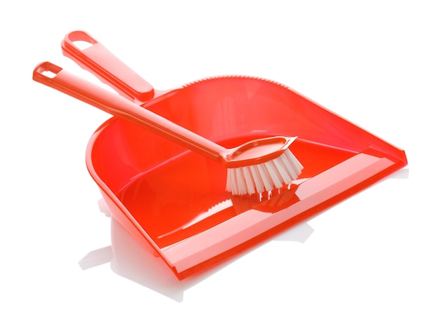 Isolated red plastic dustpan and brush