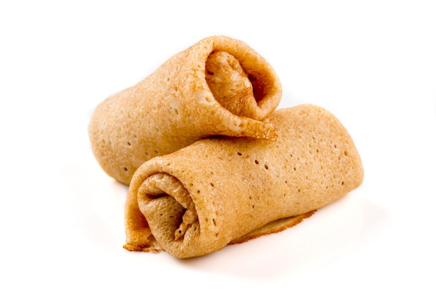 Isolated russian stuffed pancake rolls on white