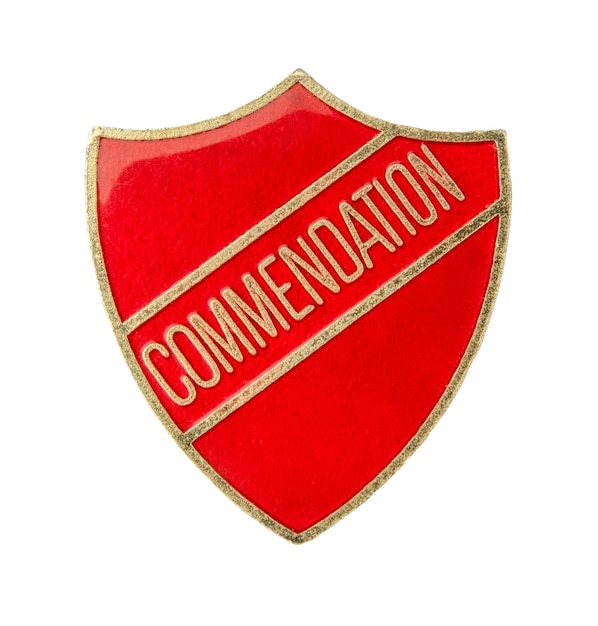 An Isolated Shield Shaped School Commendation Badge On A White Background