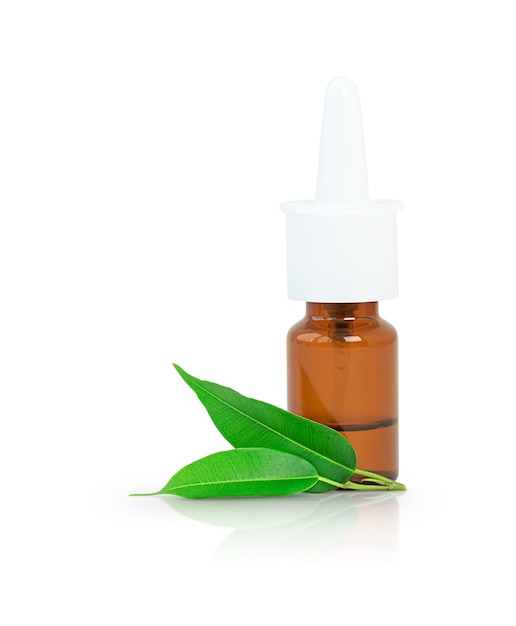 Isolated spray bottle of medicine with green leaves of  tea tree