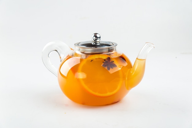 Isolated teapot of citrus tea with anise