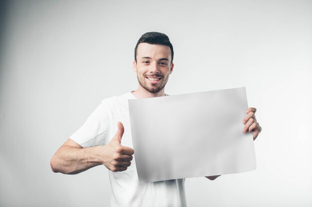 Isolated on white background man holds a poster bearded