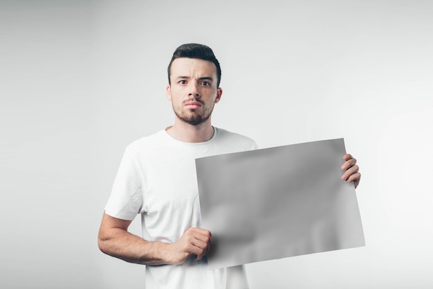Isolated on white background man holds a poster