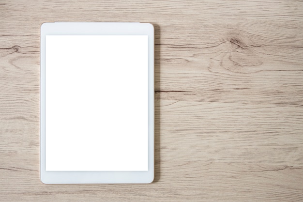 Isolated white tablet on wooden table