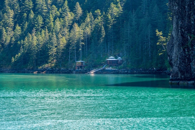 Isolated wood cabins on shoreline of Resurrection Bay