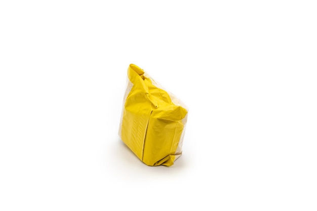 Photo isolated yellow postal package from shopping online is delivered to the buyer it's shot in the studio light in front of white background