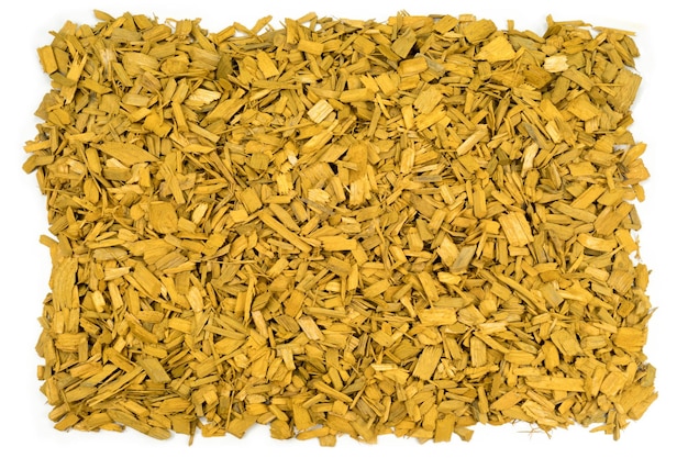 Isolated yellow wood bark mulch chips closeup