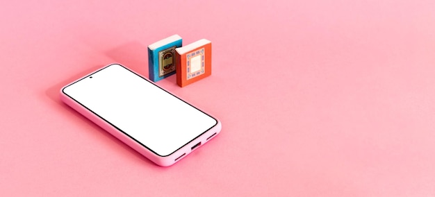 Photo isometric view of mobile phone and two books on pink background distance education