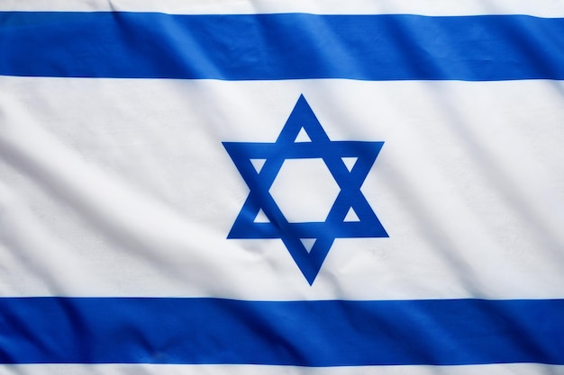 Israel flag Independence Day of Israel Israel flag beautifully waving wave with star of David over white wooden background National pride of Israel Patriotism and commonwealth Top view Mock up