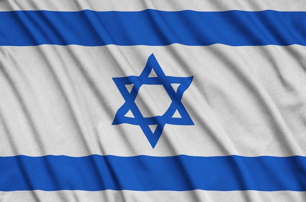 Israel flag is depicted on a sports cloth fabric with many folds.