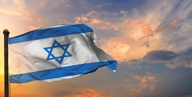 The israel waving flag and sky background.