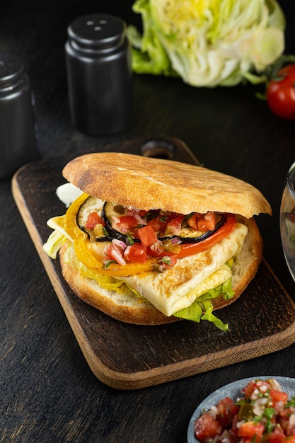 Israeli fast food sabich sandwich with vegetables eggs on wooden background vertical