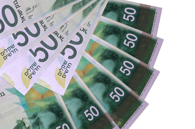 Israeli new shekels bills laying on white surface