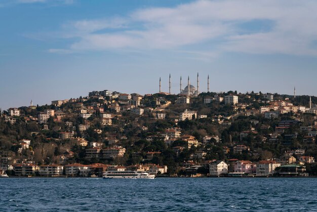 Istanbul Turkey 02252023 View of the Uskudar district of Istanbul in the Asian part of the city and the Great Mosque of Chamlyja from the waters of the Bosphorus on a sunny day