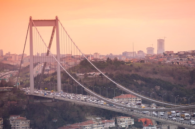 Photo istanbul turkey january 10 2015 fatih sultan mehmet bridge view connects asia and europe during the sunset