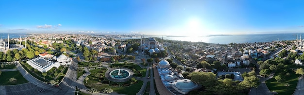 Istanbul Turkey Sultanahmet with the Blue Mosque and the Hagia Sophia with a Golden Horn on the background at sunrise Cinematic Aerial view