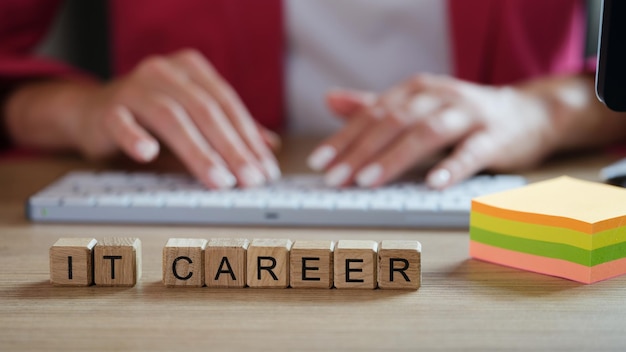 It career words collected from wooden cubes and stack of note papers on table female programmer