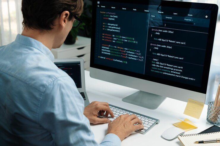 Photo it developer working online software development on pc and laptop pecuniary